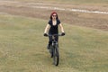 Girl on a mountain bike on offroad, beautiful portrait of a cyclist in rainy weather, Fitness girl rides a modern carbon fiber