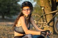 Girl on a mountain bike on offroad, beautiful portrait of a cyclist at sunset Royalty Free Stock Photo