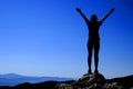 Girl on Mountain Top Silhouette Arms Raised for Success and Exhuberance