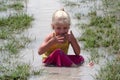 Girl in muddy water Royalty Free Stock Photo