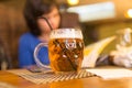 Girl with a mug of beer in a restaurant Royalty Free Stock Photo