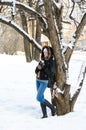 Girl with a mug of tea leaning against a tree, a city in the background Royalty Free Stock Photo