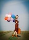 Girl with multicolored balloons and bag Royalty Free Stock Photo