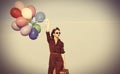 Girl with multicolored balloons and bag Royalty Free Stock Photo