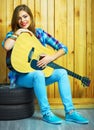 Girl musician play on acoustic guitar Royalty Free Stock Photo