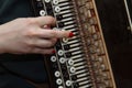 Girl musician plays the the Russian bayan button accordion and singing.