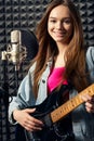 Girl musician in recording studio playing electric guitar Royalty Free Stock Photo