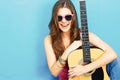 Girl musician sitting on a floor with guitar