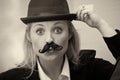 Girl with mustache and bowler hat Royalty Free Stock Photo