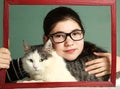 Girl in myopia glasses hug big siberian cat Royalty Free Stock Photo