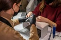 girl nail specialist in hands with a nail file saws the nails of a girl client during