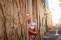 Girl in narrow street in European provincial town. Royalty Free Stock Photo
