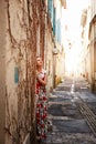 Girl in narrow street in European provincial town. Royalty Free Stock Photo