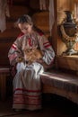 Girl with a rabbit, national clothes, traditional life in the house Royalty Free Stock Photo