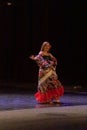 A girl in a national dress dances a gypsy dance