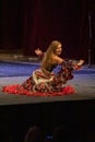 A girl in a national dress dances a gypsy dance