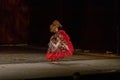 A girl in a national dress dances a gypsy dance