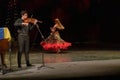 A girl in a national dress dances a gypsy dance