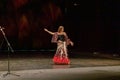 A girl in a national dress dances a gypsy dance