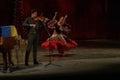 A girl in a national dress dances a gypsy dance