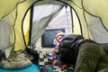 The girl on the nature lies in a tent and watches the old TV Royalty Free Stock Photo