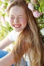 Girl on the nature of a rose. Beautiful red-haired girl near roses.