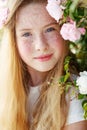 Girl on the nature of a rose. Beautiful red-haired girl near roses.