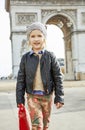Girl near Arc de Triomphe in Paris, France going forward