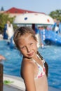 Girl near an attraction with water at a water park Royalty Free Stock Photo