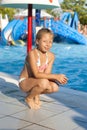 Girl near an attraction with water at a water park Royalty Free Stock Photo