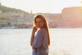 Girl near the river against the sky having fun. Sunset. Summer vibes