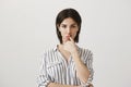 Girl need to find way out of problem. Portrait of focused and serious businesswoman in trendy striped blouse holding