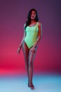 Girl in neon green swimsuit and Royalty Free Stock Photo