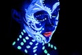 Girl with neon make-up in color light Royalty Free Stock Photo