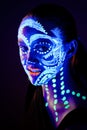 Girl with neon make-up in color light Royalty Free Stock Photo