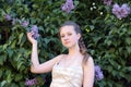 Girl next to a flowering lilac Royalty Free Stock Photo