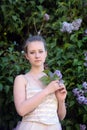 Girl next to a flowering lilac Royalty Free Stock Photo