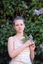 Girl next to a flowering lilac Royalty Free Stock Photo