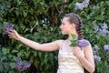 Girl next to a flowering lilac Royalty Free Stock Photo