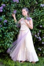 Girl next to a flowering lilac Royalty Free Stock Photo