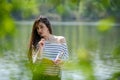 Girl with a notebook in park near the river Royalty Free Stock Photo