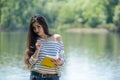 Girl with a notebook in park near the river Royalty Free Stock Photo