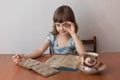 Girl numismatist plays with a coin Royalty Free Stock Photo