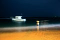 A girl by the ocean at night