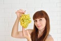 Girl offers a bunch of grapes Royalty Free Stock Photo