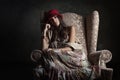 Girl in old armchair Royalty Free Stock Photo