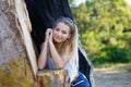Girl by the old tree in the forest Royalty Free Stock Photo