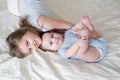 Girl older sister hugging her little baby boy brother on bed at home Royalty Free Stock Photo