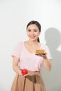 The girl in one hand has an apple, in the other hand a cake. Royalty Free Stock Photo