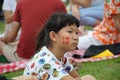 A girl with one side of her face painted during a gathering at the Marina Barrage Roof Garden